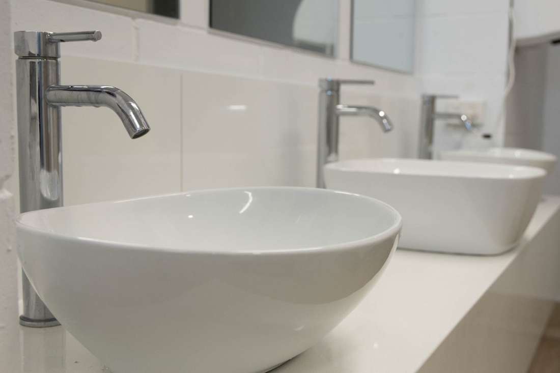 Fresh ensuite bathroom with vessel basins at CALI Backpackers
