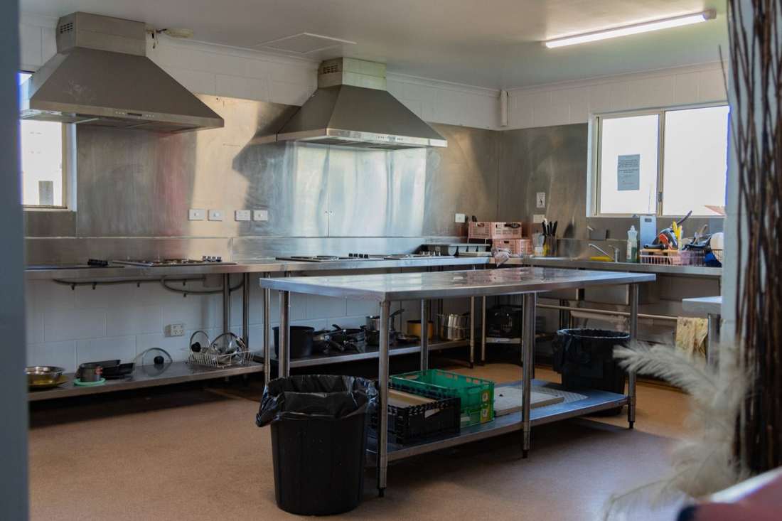 Fully equipped communal kitchen with stainless steel benches