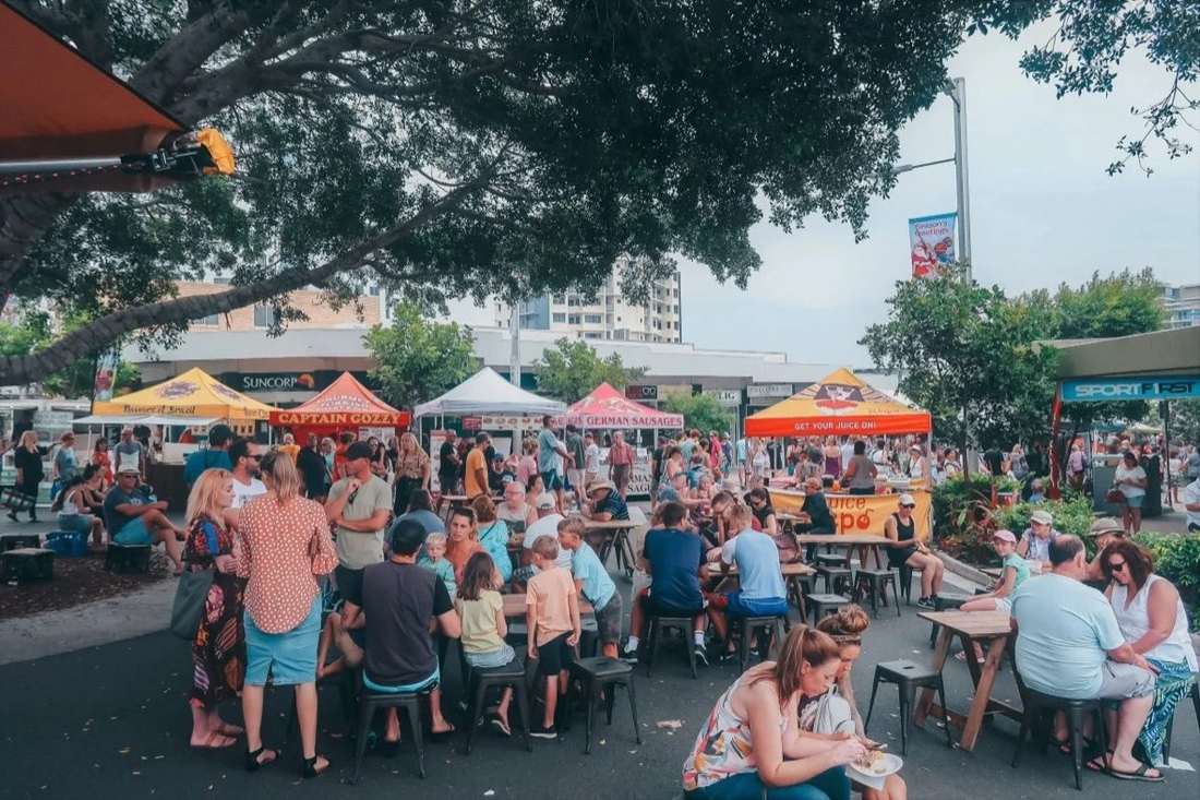 Food stalls and crowds at the Caloundra Street Fair on Bulcock Street